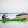 A man stationing a kayak near a sea lion colony on the sands of Estero Beach, Mexico
